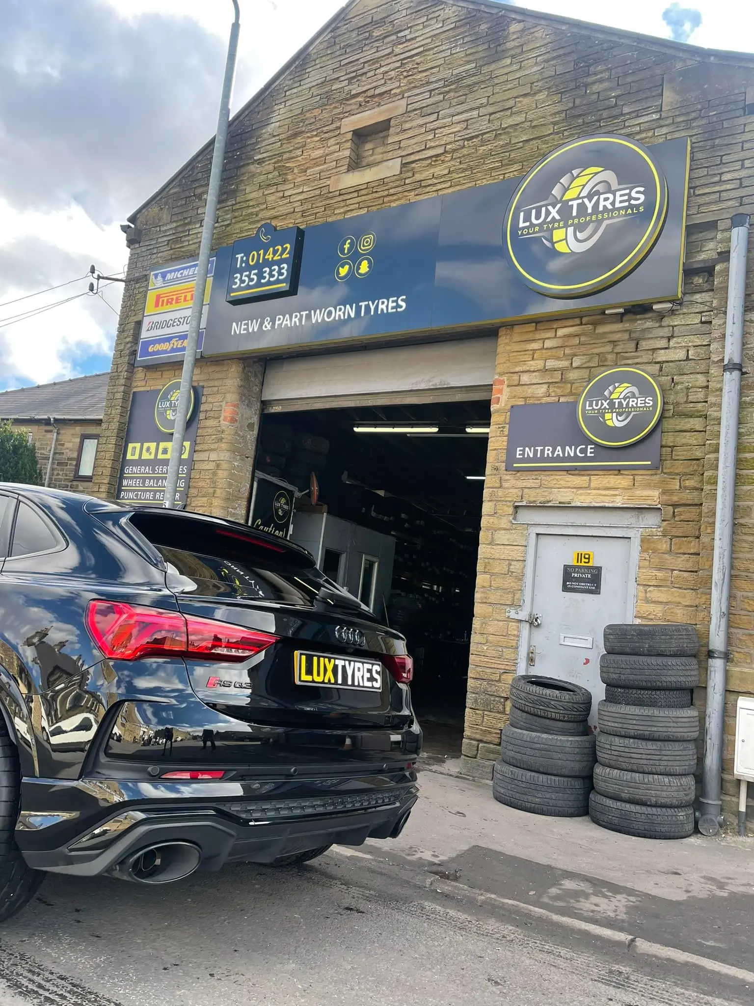 Audi RS Q3 outside Lux Tyres workshop at 119 Hopwood Lane