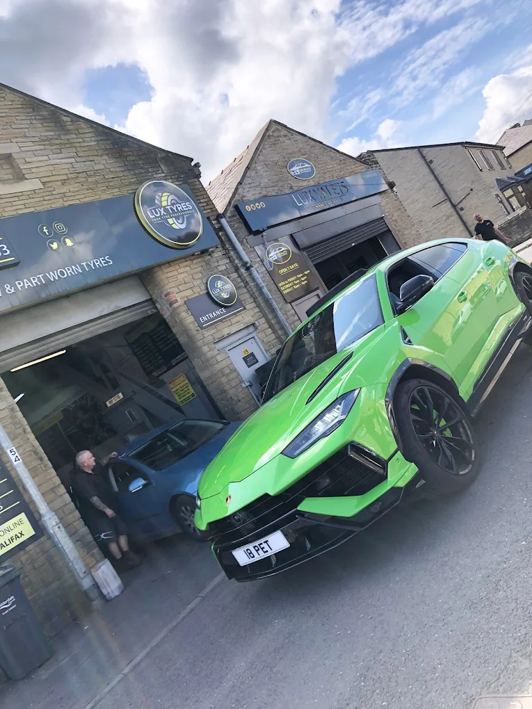 Green Lamborghini Urus outside Lux Tyres